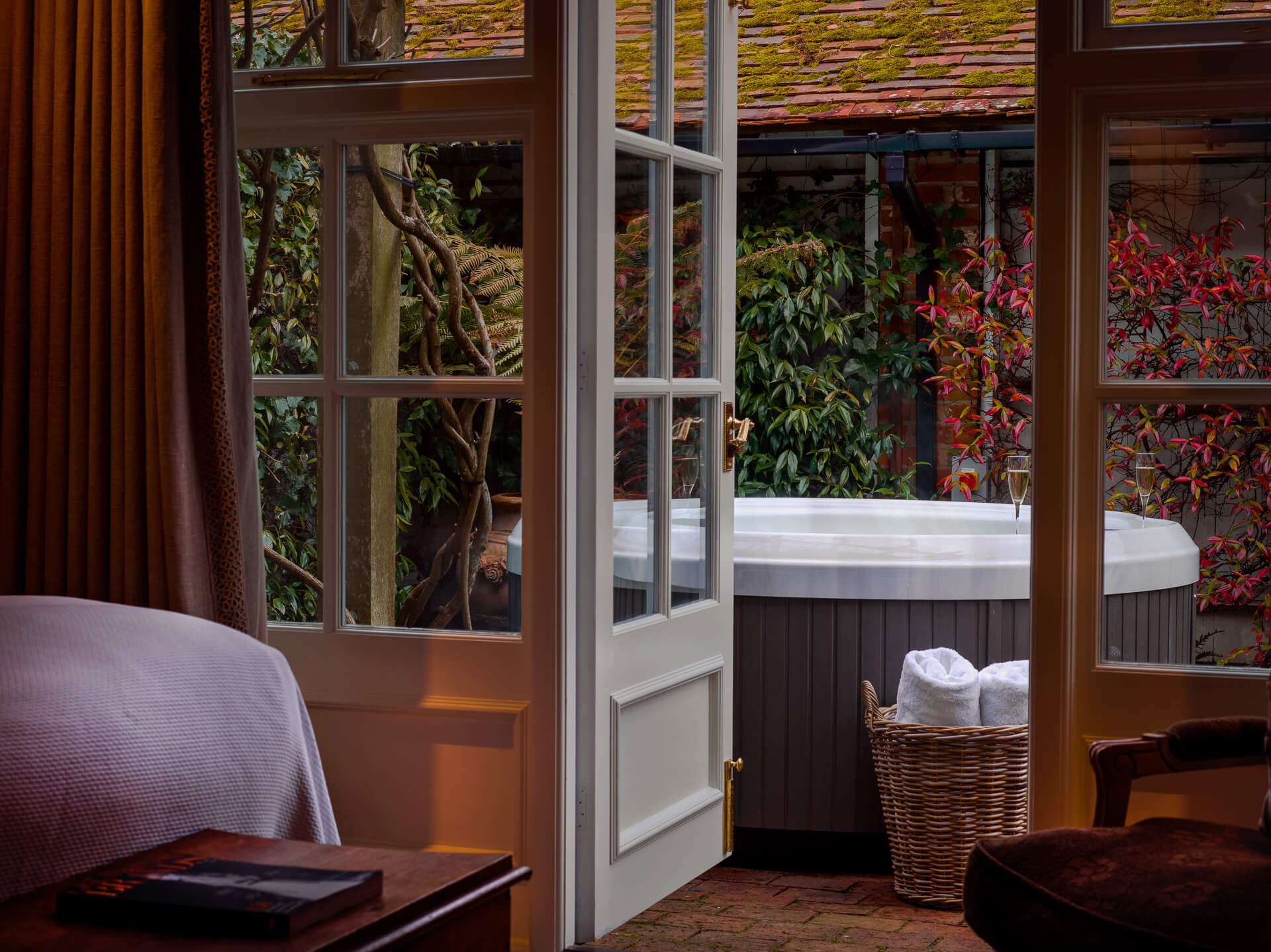 Outdoor hot tub viewed through French doors.