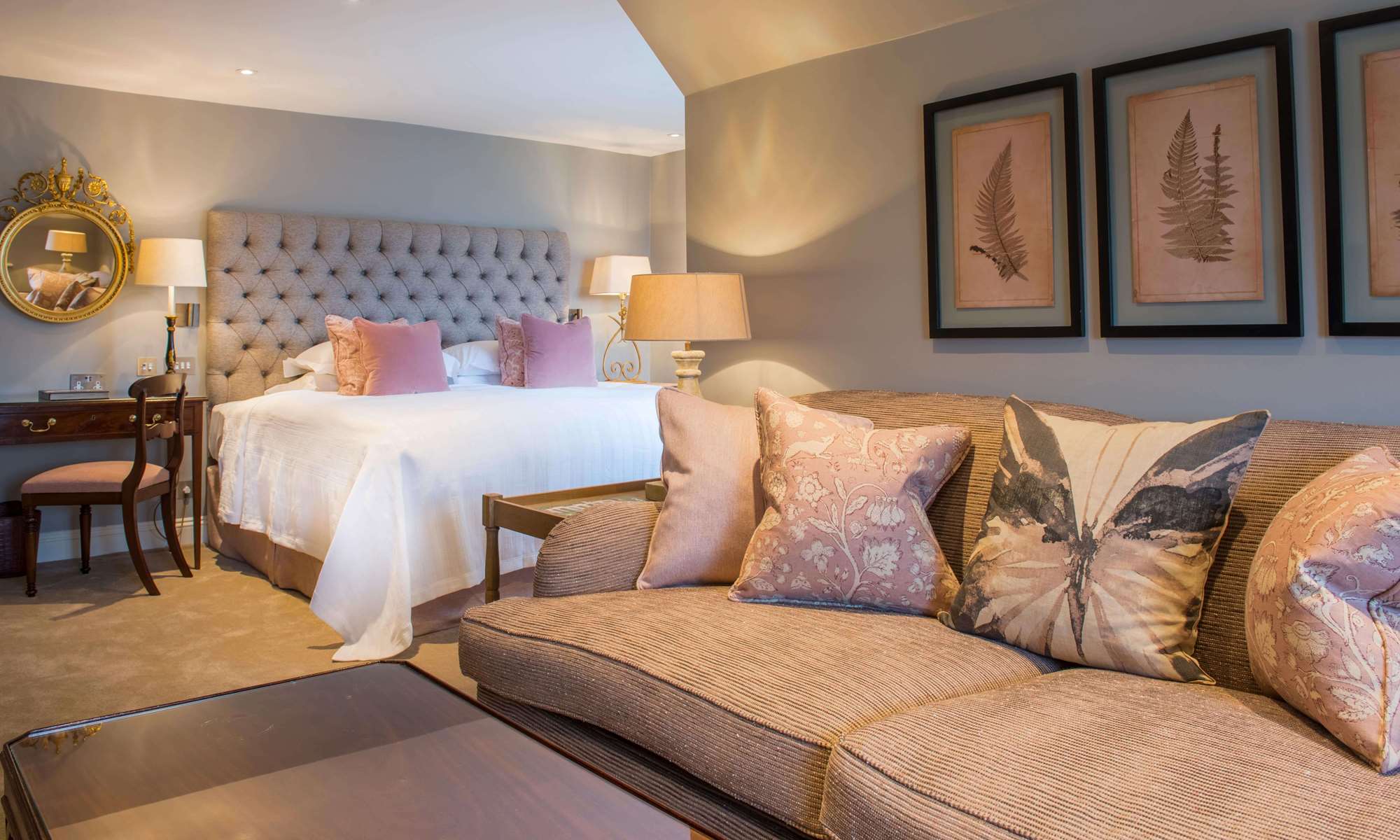 Cosy bedroom with sofa and pastel cushions.