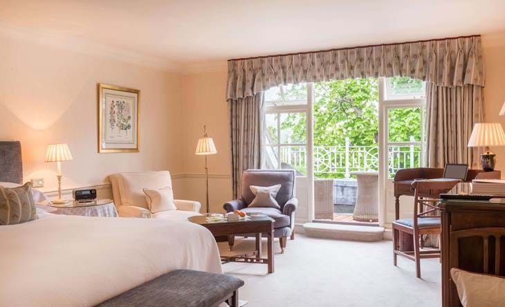 Spacious bedroom with large window and seating area.