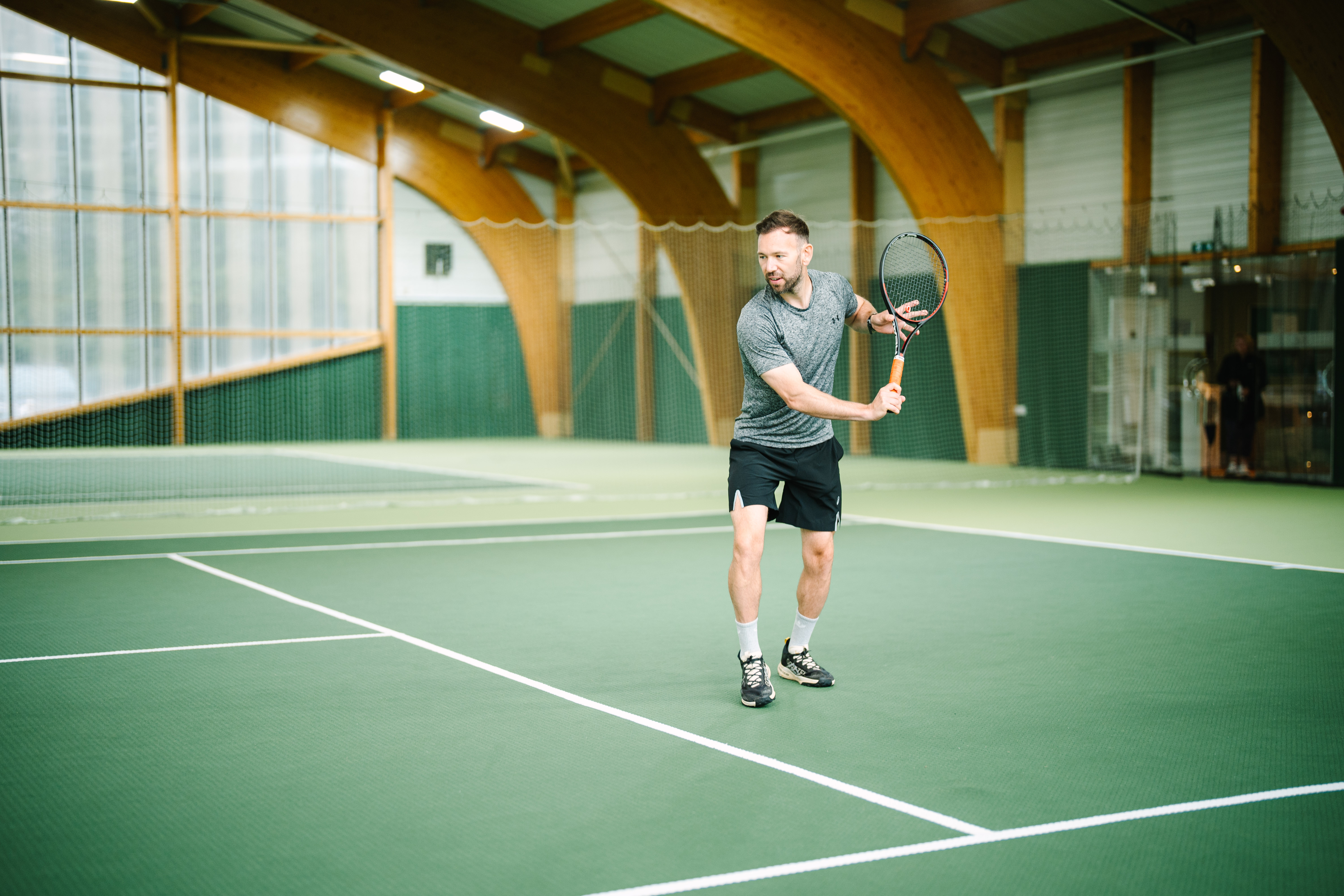 Man playing tennis at the indoor tennis court