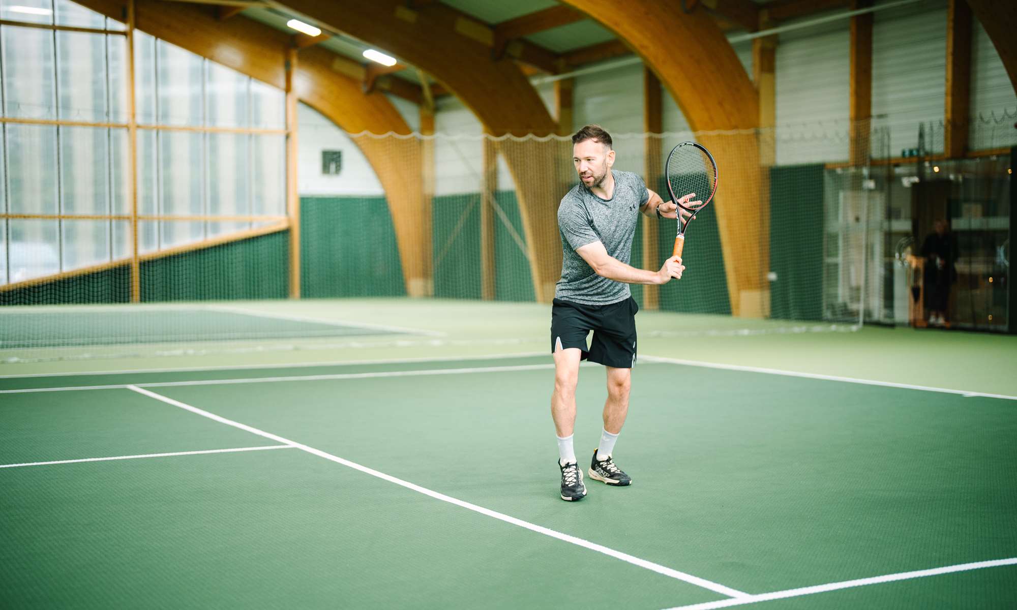 Man playing tennis at the indoor tennis court