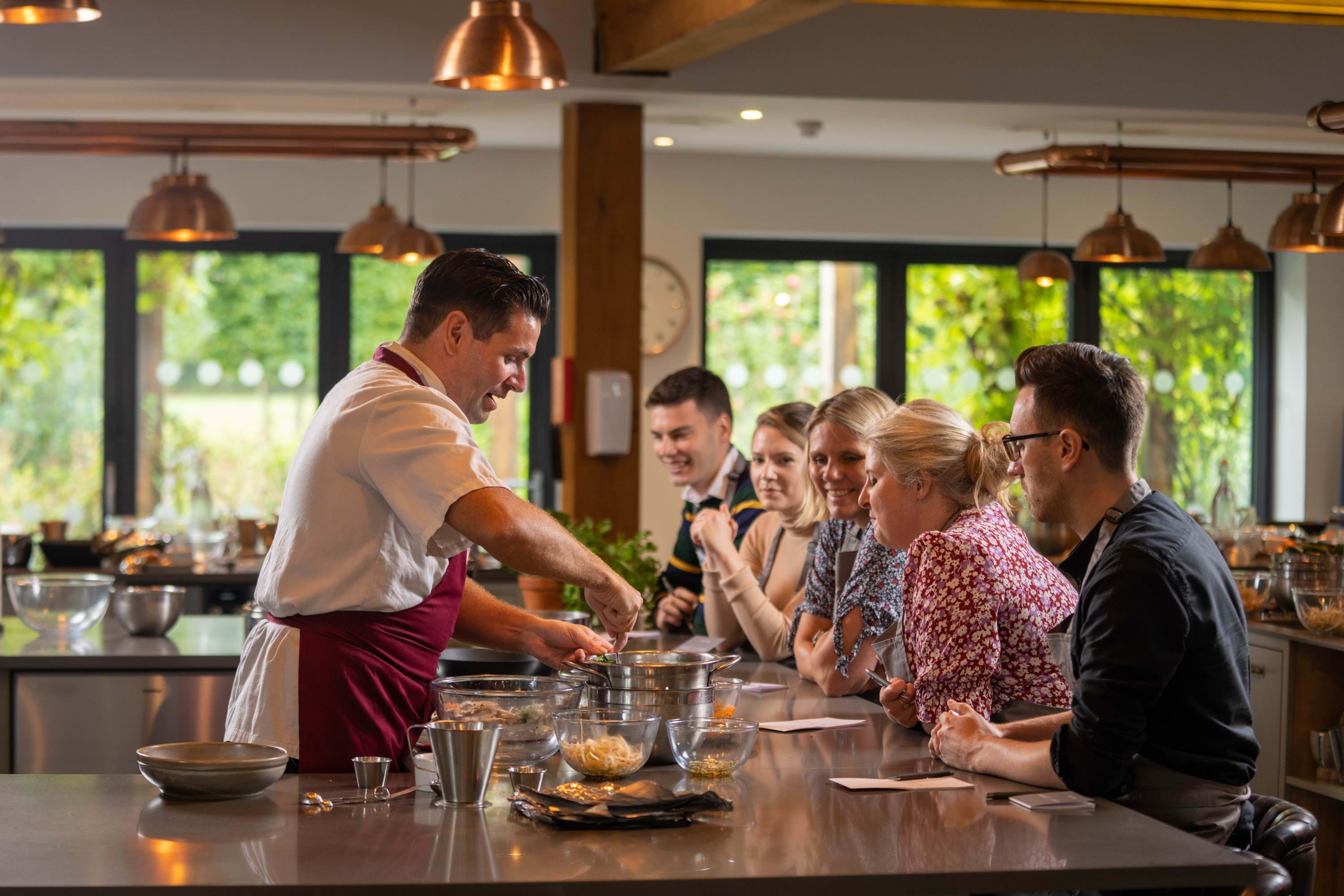 Chef performing cookery classes to students 